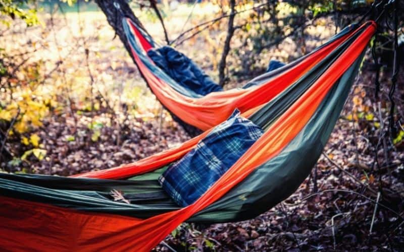 Two single hammocks hanging from trees