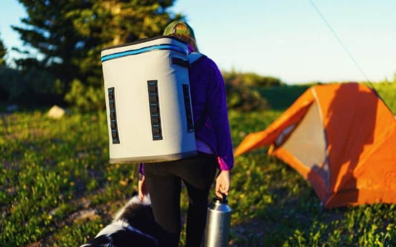 Woman carrying a soft cooler on her back