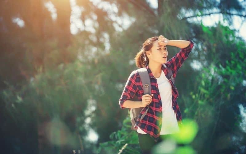 Woman overheating wearing cotton on a hike