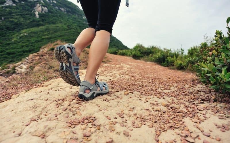 Woman walking uphill in hiking sandals