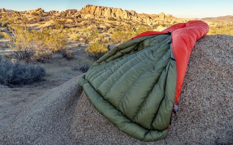 Camping down quilt lying on a rock