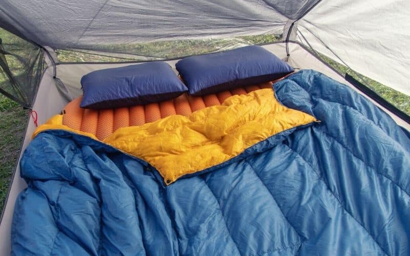Camping quilt spread over a sleeping pad