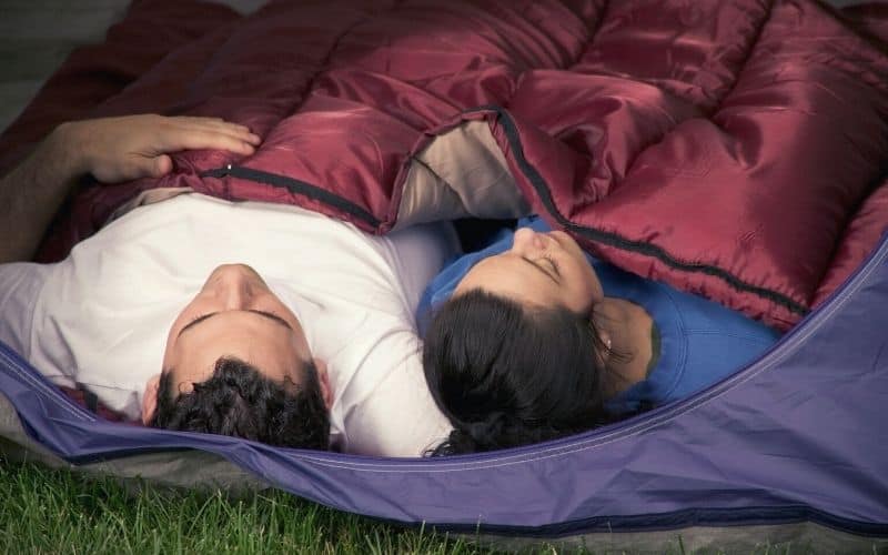 Couple sleeping under a camping quilt