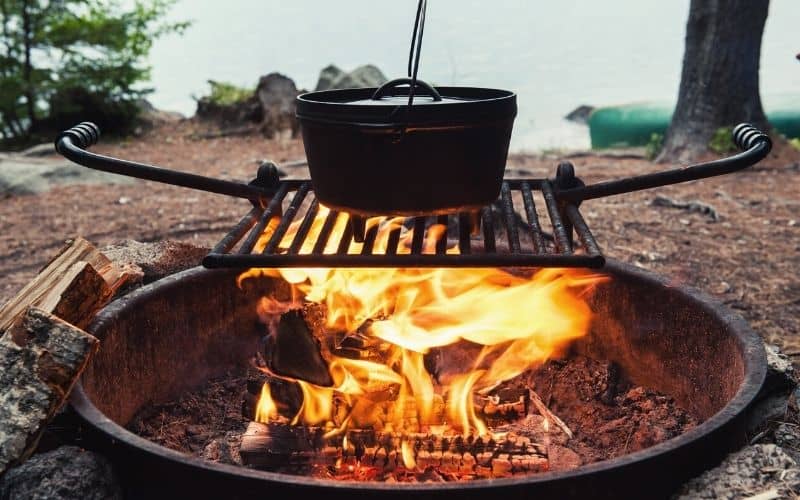 Dutch oven sitting over a campfire
