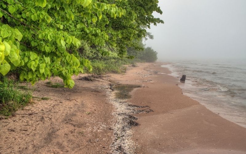 The sandy shore of Harrington Beach lies on Lake Michigan