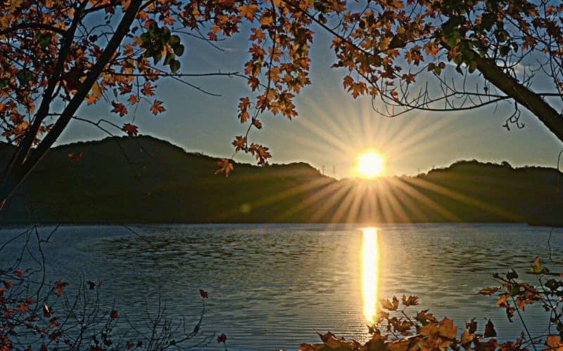 Sun rising between two hills over Radnor Lake