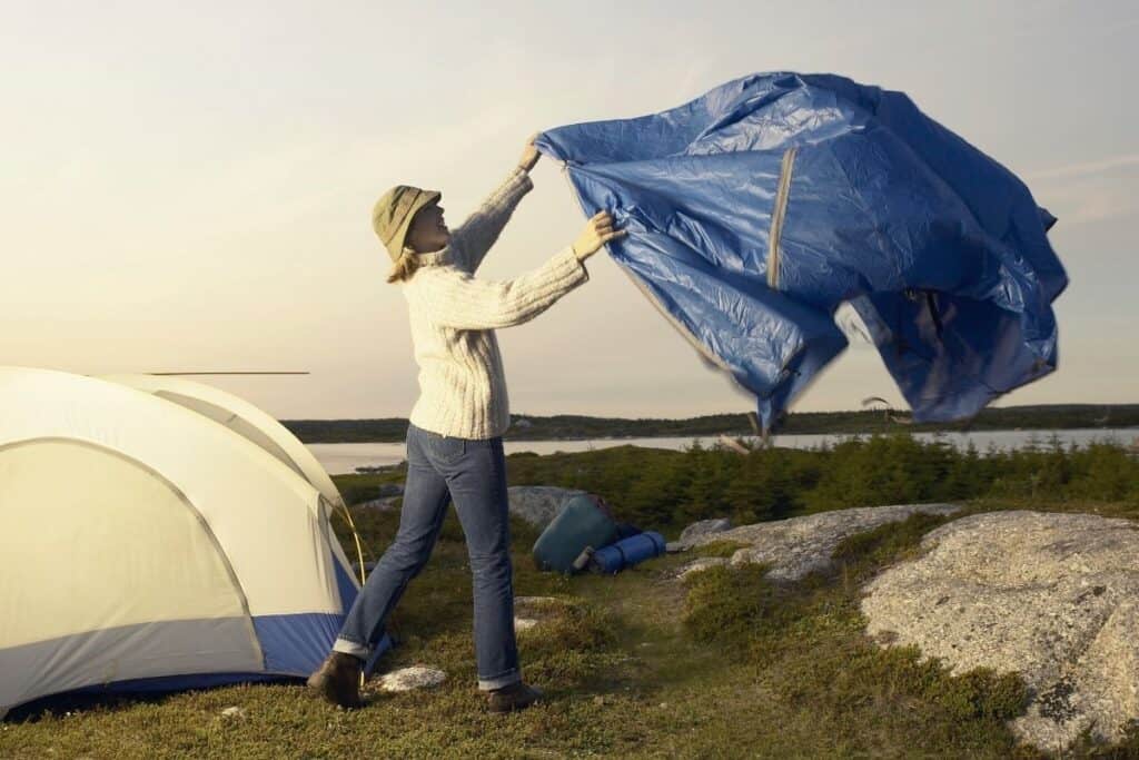 Woman laying out a tarp sheet