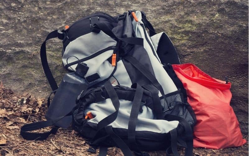 Water bottle sitting next to backpack