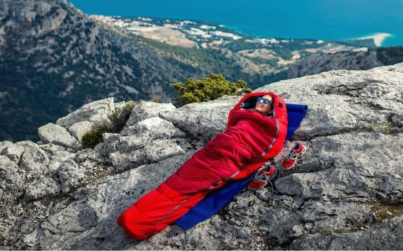 Woman lying in a mummy style sleeping bag
