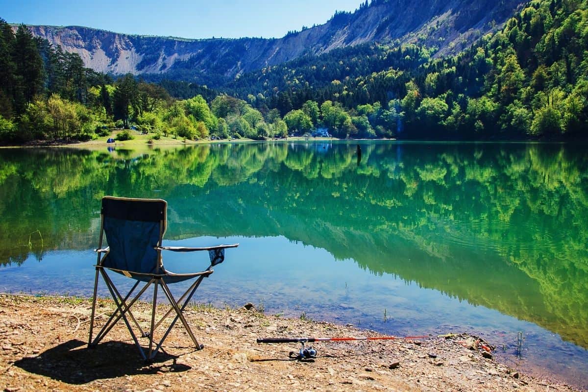 Camping chair sitting in front of lake