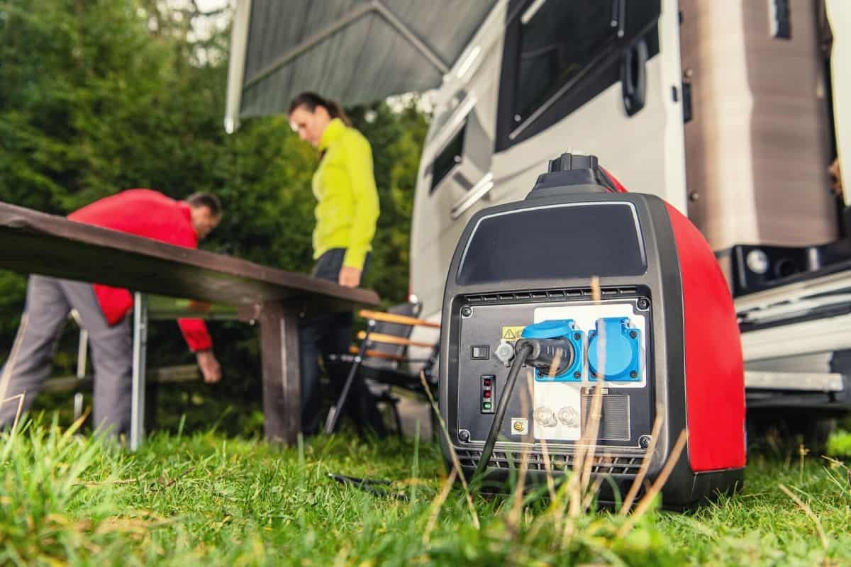 An electrical generator in the grass in front of an RV