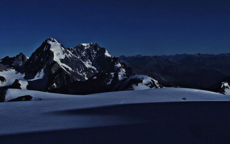 Climbers crossing the Cevedale Glacier with Gran Zebru in the background.