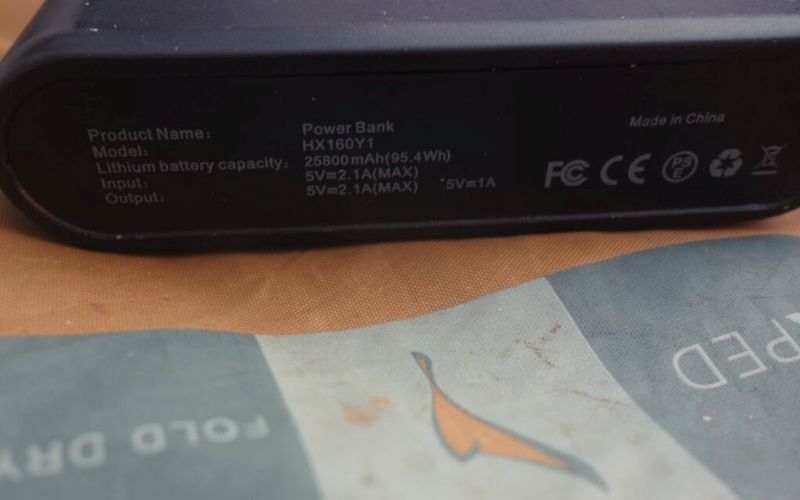 Close up of specs on side of power bank sitting on an exped sleeping mat