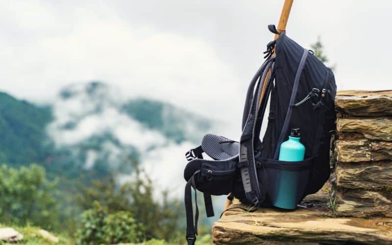 Metal water bottle in side pocket of a backpack