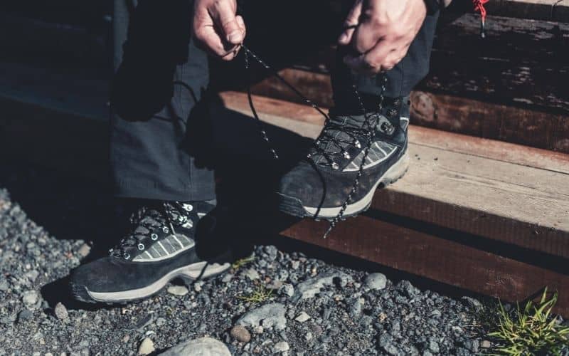 Man putting on hiking boots