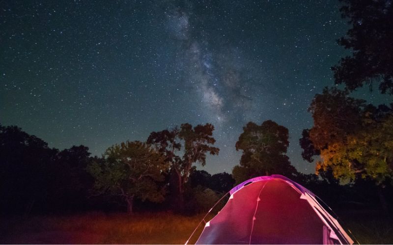 Tent pitched underneath the starry night sky