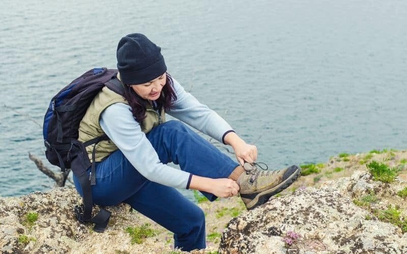Woman adjusting her hiking boot