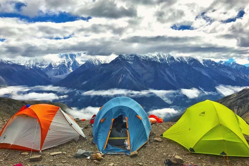 different types of tent in front of snowy mountains
