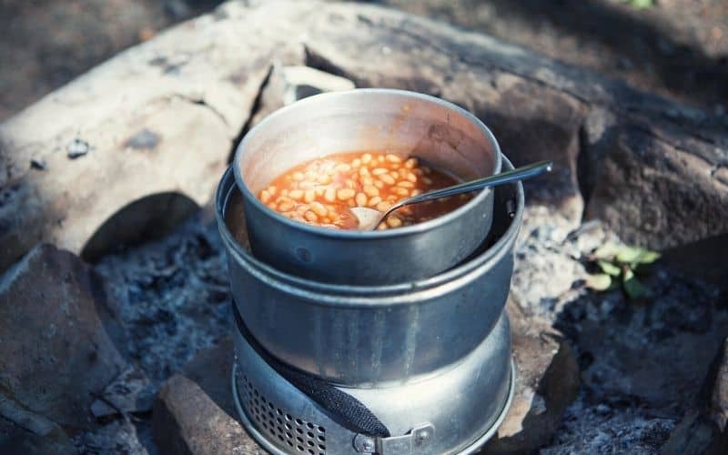 Beans being cooked on a campfire