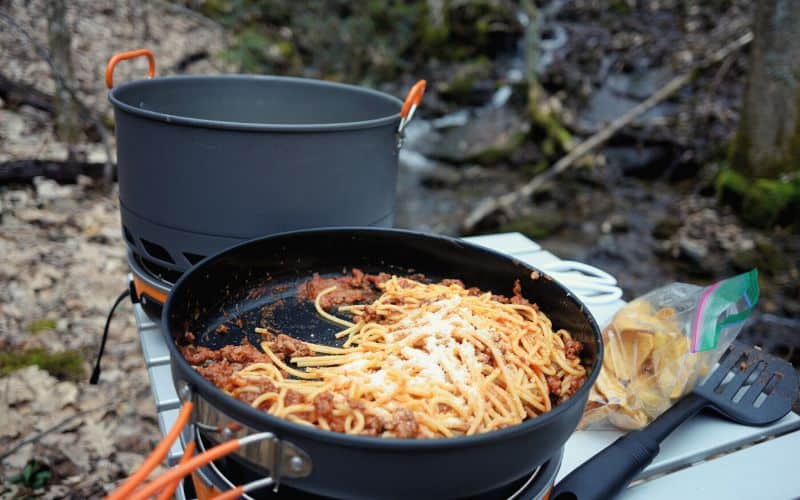 Camping pan with spaghetti cooked inside of it