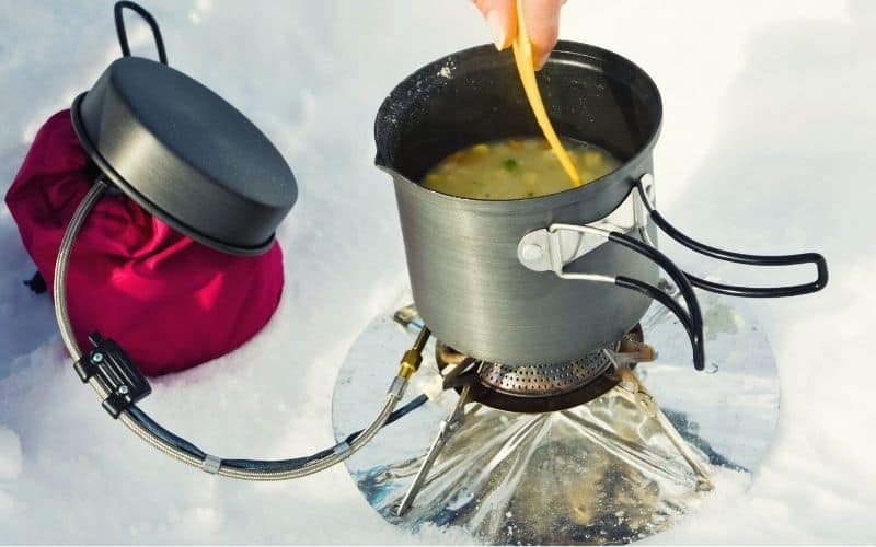 Soup heated up with a camp stove in the snow