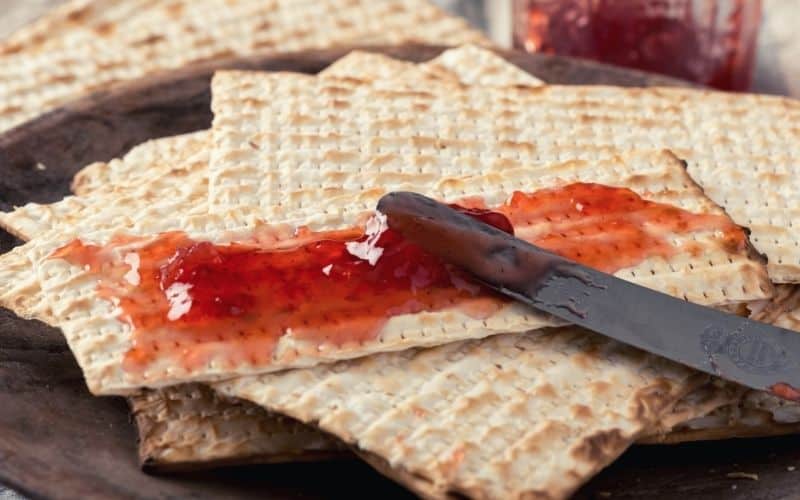 Strawberry jam spread on crackers