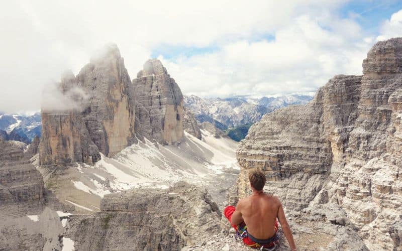 hiker staring at tre cime di lavaredo