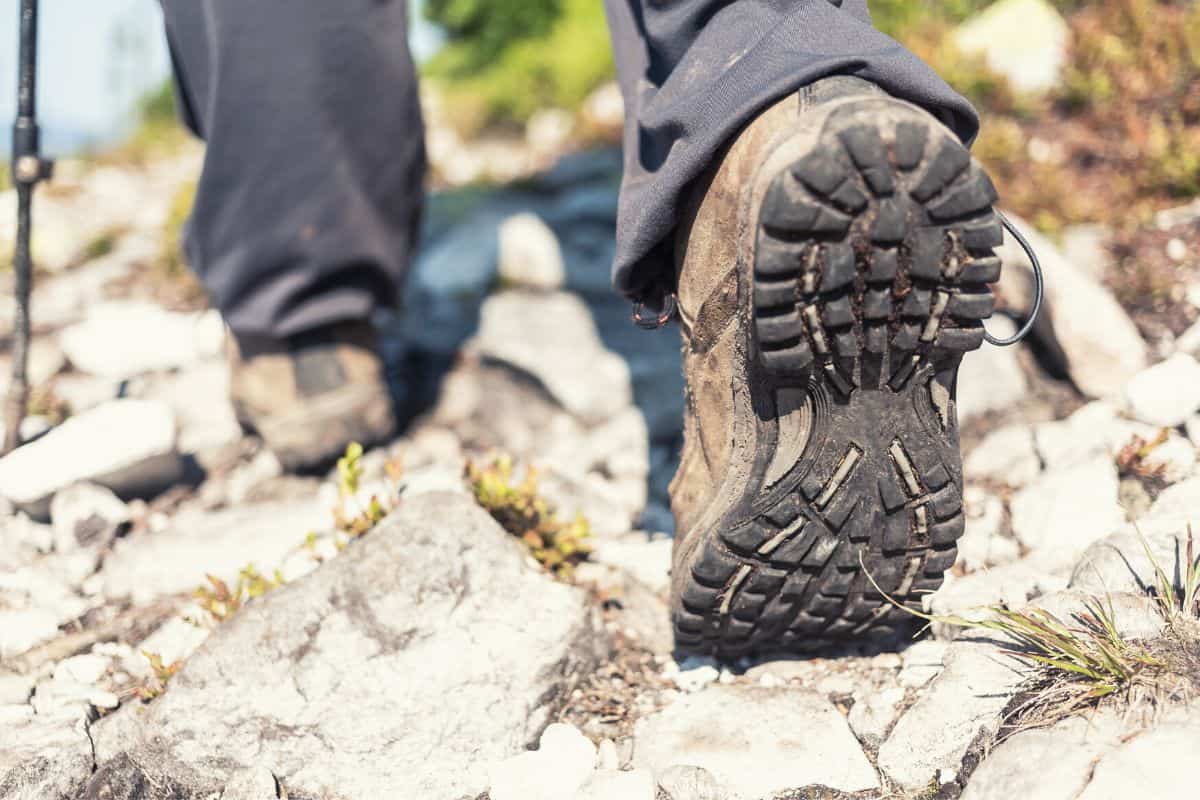 Close up of hiking boots walking over rocky terrain