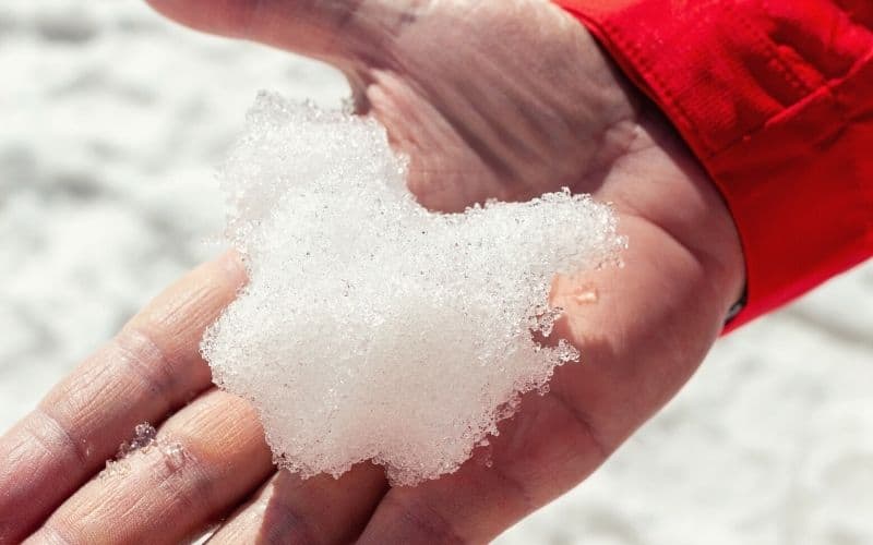 hiker holding hanful of snow