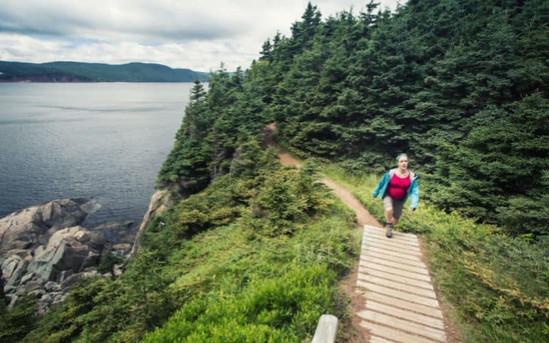 pregnant woman hiking coastal trail