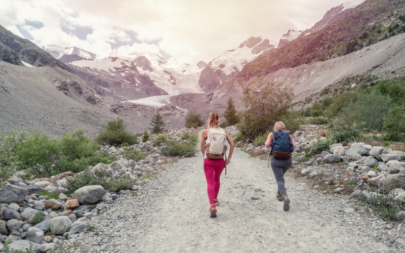 two women hiking along valley trail