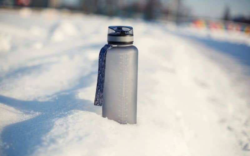 water bottle sitting in snow