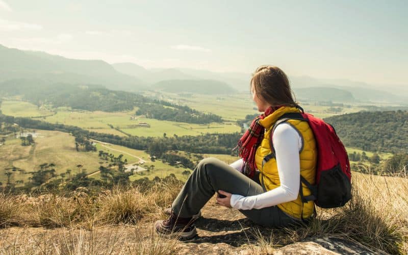 woman sitting on hillside