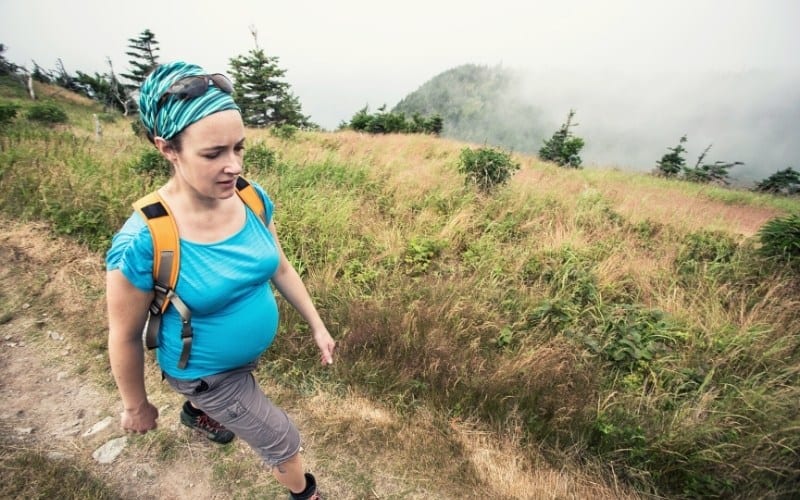 women hiking along dirt path