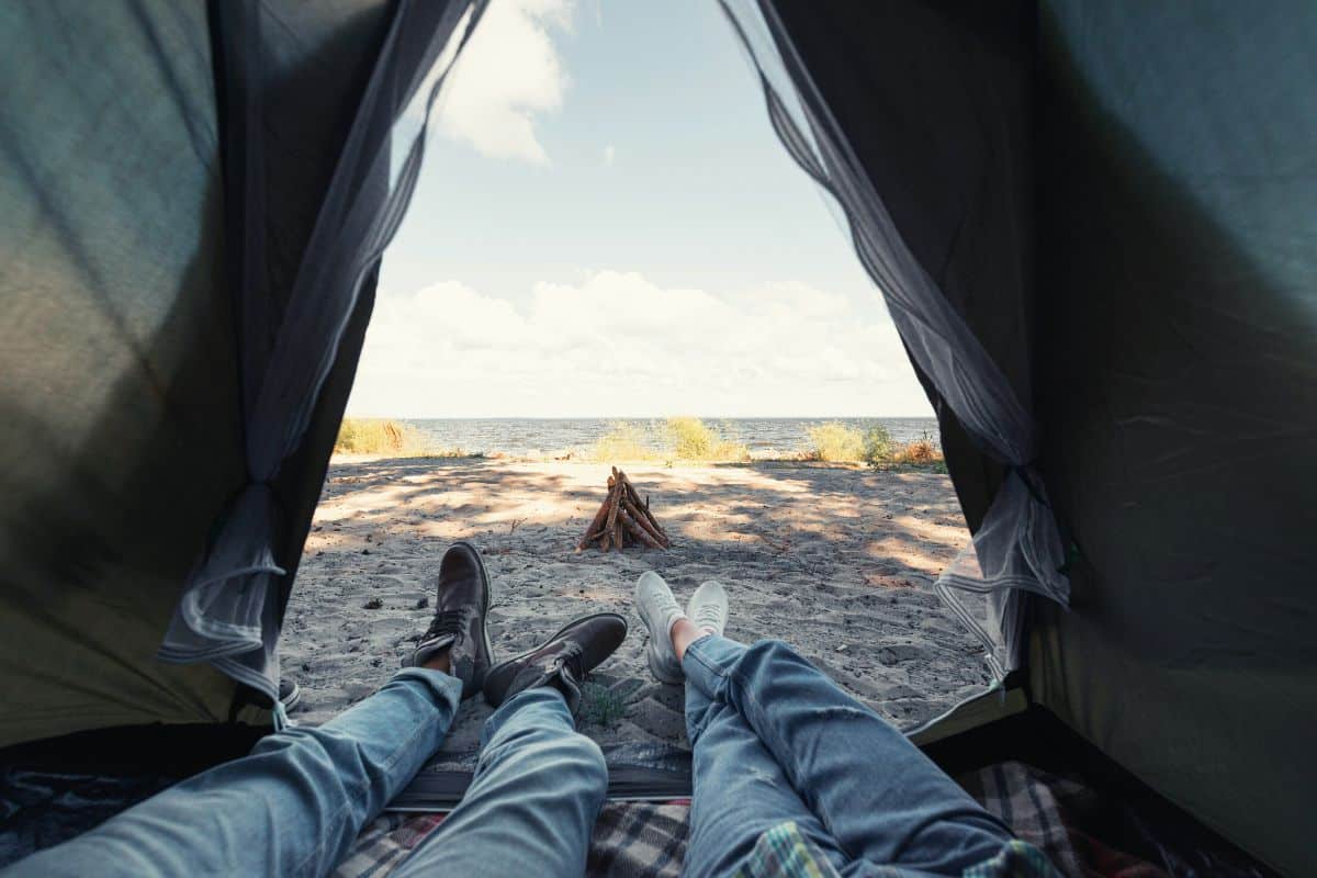 Campers legs sticking out of tent