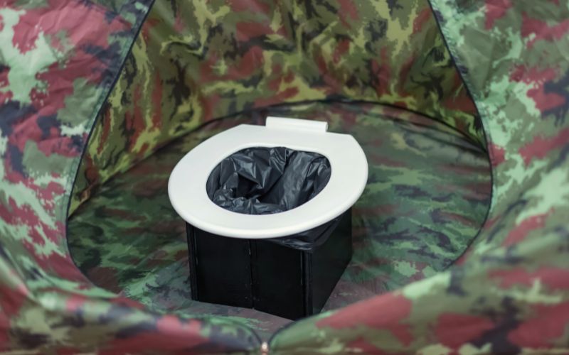 Bucket toilet with bag inside tent