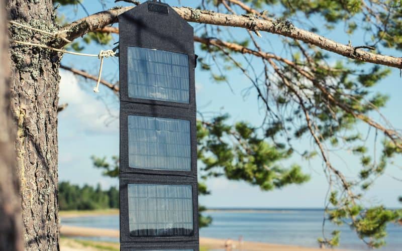 Foldable solar panels hanging from a tree