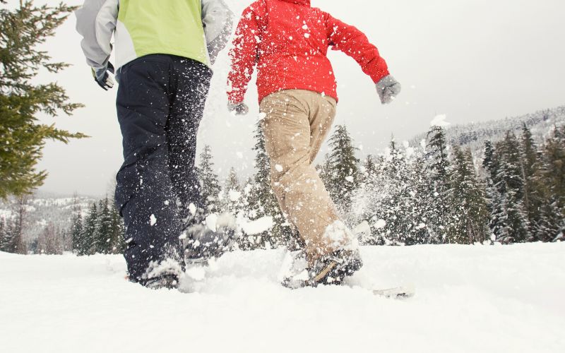 Hikers walking in snow in snowshoeing boots