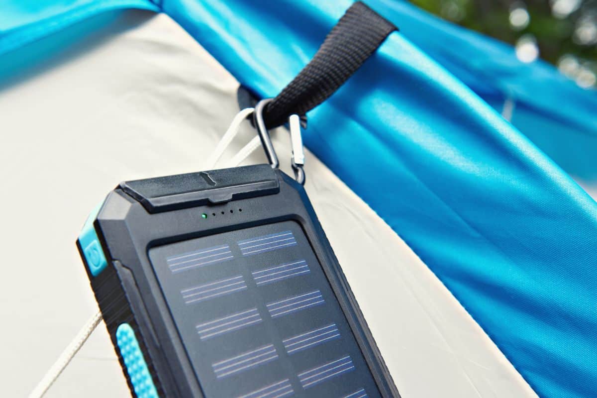Portable solar charger attached to a tent