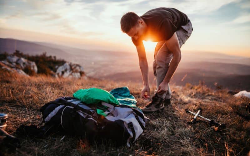 Man organising camp bedding
