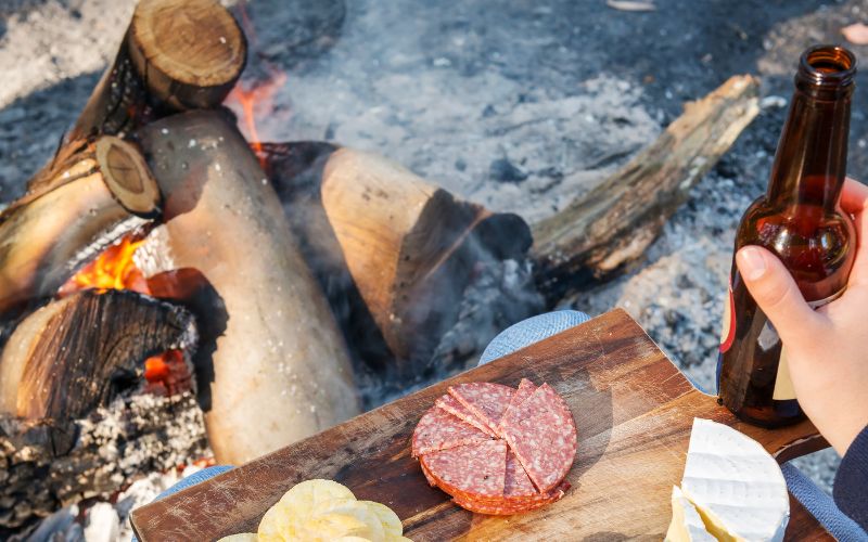 Beer and cheese in front of camp fire