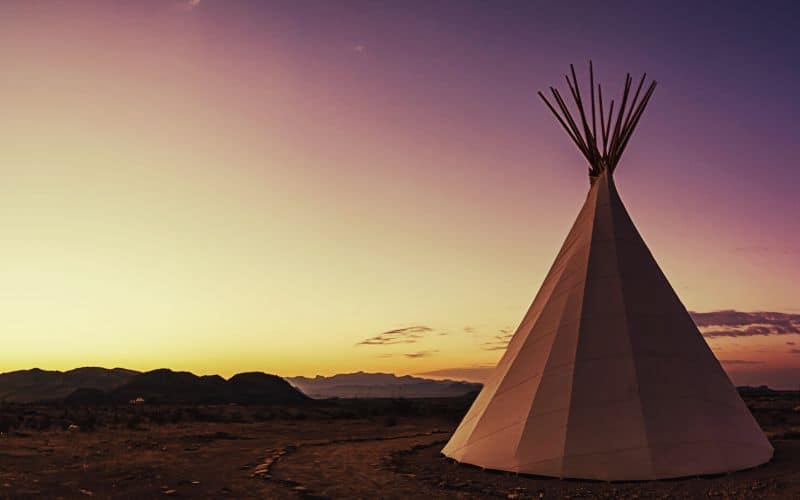 Canvas tipi in front of a sunset
