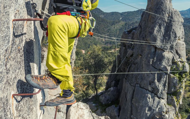 Close up of mans feet climbing via Ferrata