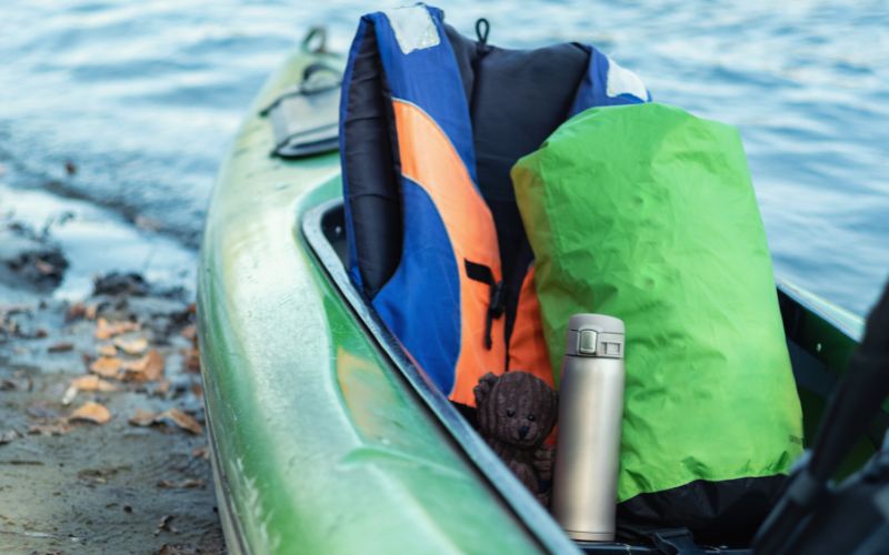 Compression sack and a life jacket inside a canoe