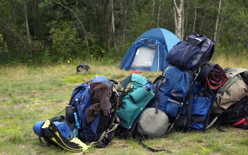 Lots of camping gear sitting in front of a tent
