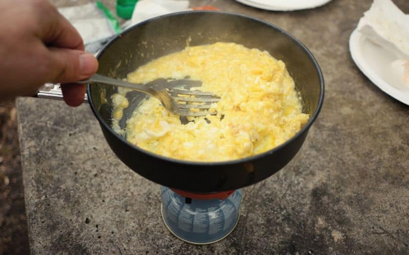 Scrambled egg cooked on camping stove