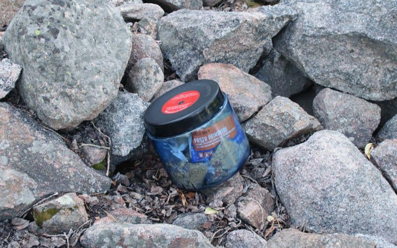 Small bear canister nestled in amongst rocks
