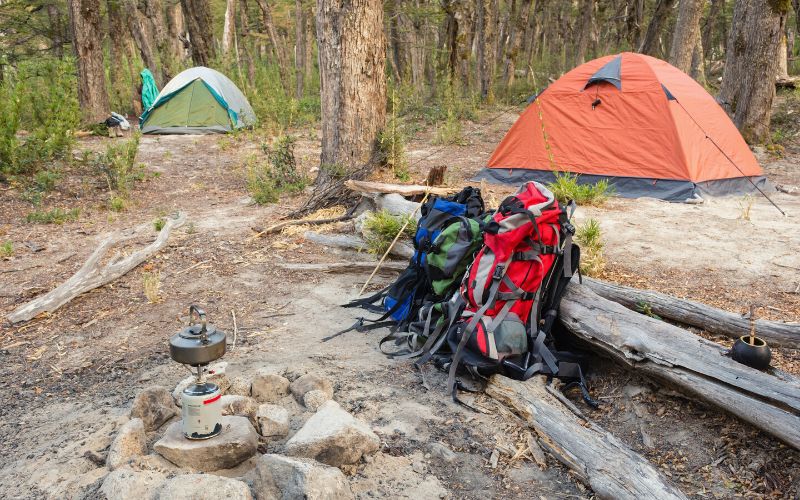 camping gear in front of two tents
