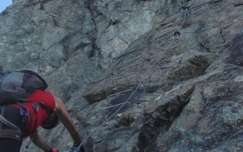 hiker using iron rungs