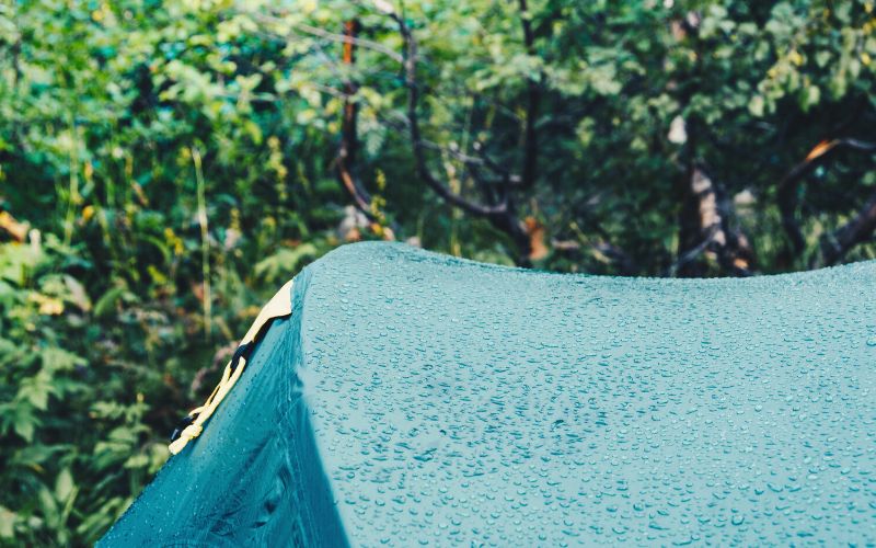 Close up of the roof of a tent with water beaded up on it